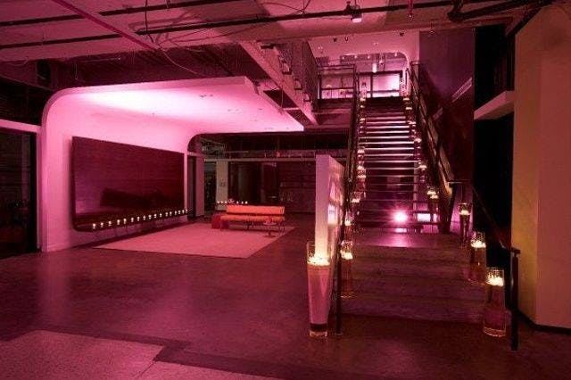 Stylish event space with illuminated staircase, perfect for upscale gatherings and celebrations.