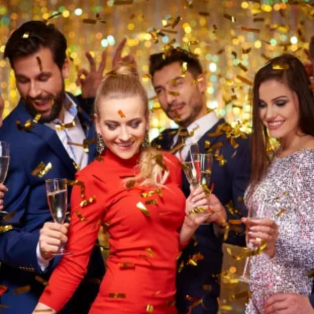 Vibrant gala event at IKON Event Space with attendees enjoying champagne and confetti.