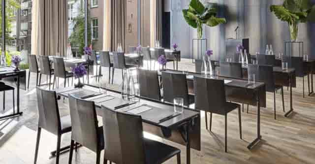 Modern Symphony Room with natural light, perfect for corporate meetings and workshops.