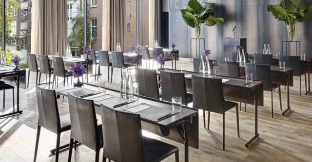 Modern Symphony Room with natural light, perfect for corporate meetings and workshops.