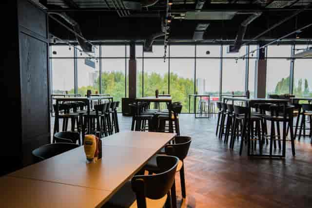 Modern event space at Allianz Stadium with floor-to-ceiling windows for networking.