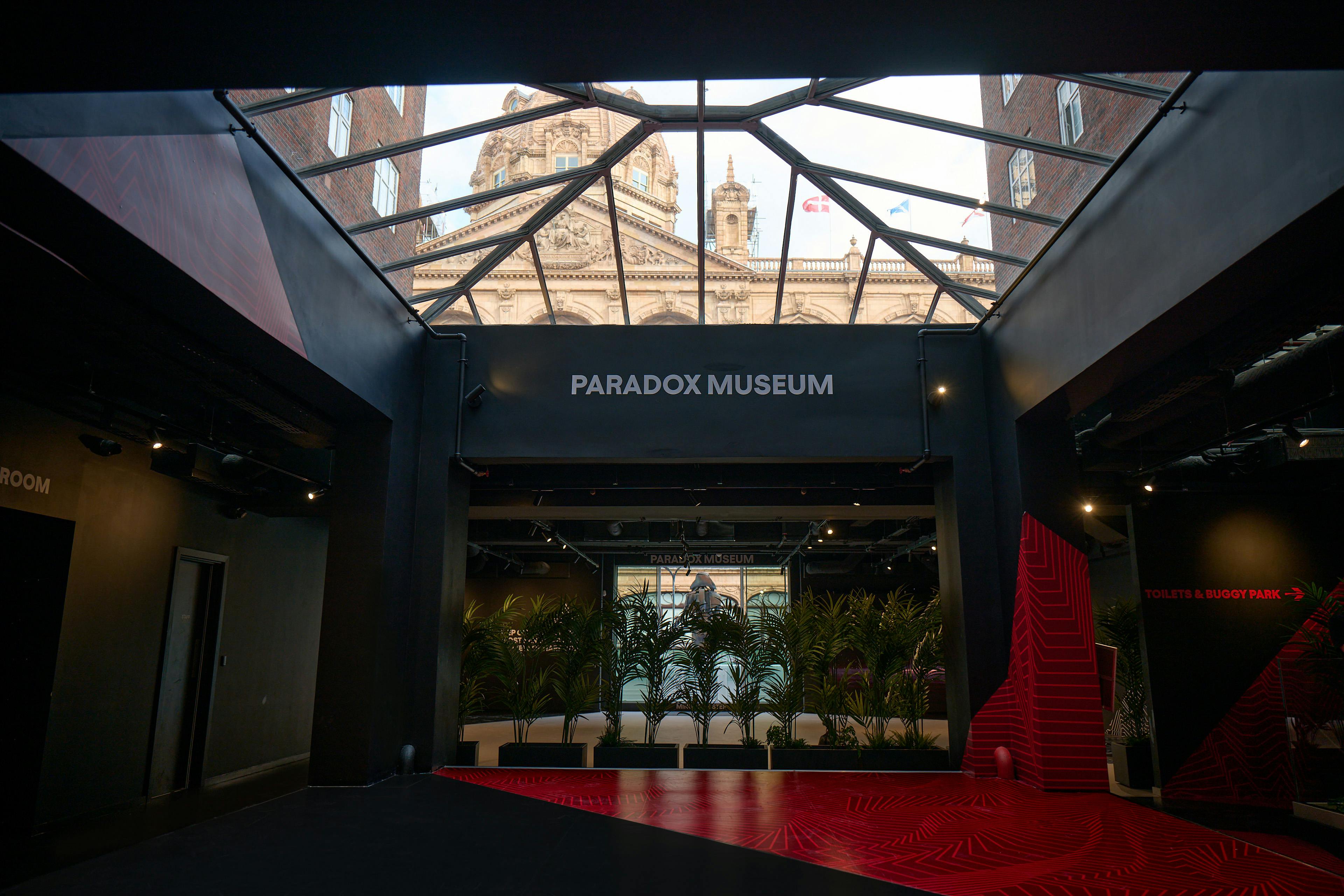 Modern event space with glass ceiling at Paradox Museum London for innovative meetings.