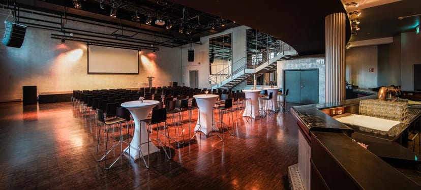 Versatile event space at Palais, Kulturbrauerei with modern decor for presentations and networking.