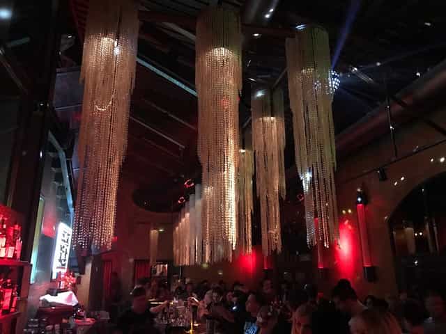 Stylish event space at Club Soda 23 with elegant chandeliers for upscale gatherings.