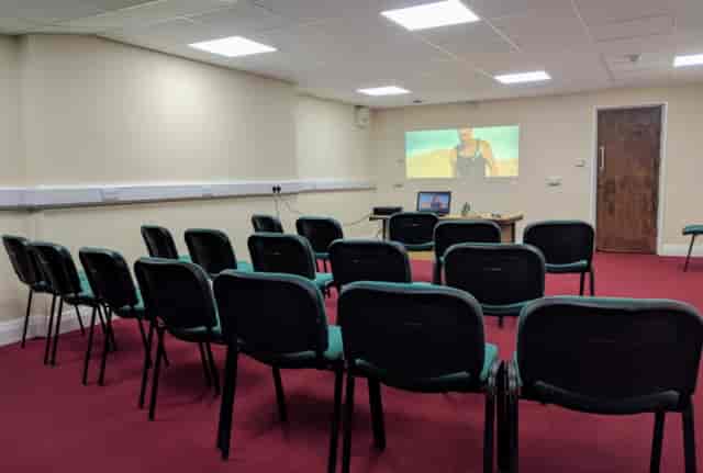 Lozells Community Centre meeting room with chairs and projection screen for presentations.