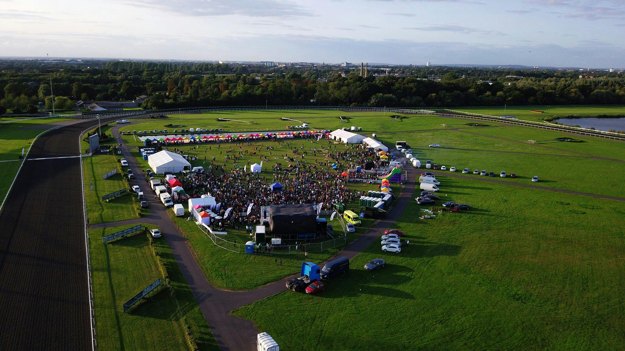 Kempton Park Racecourse outdoor event with tents, crowd, ideal for festivals and gatherings.