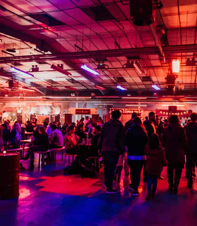 Vibrant kitchen event space with dynamic lighting for networking and mingling.