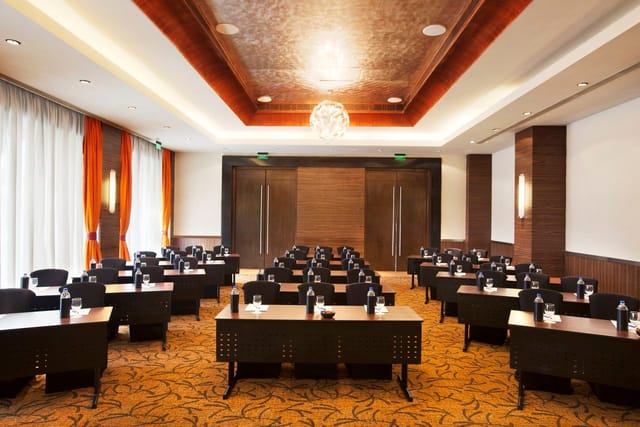 Burgundy meeting room at Novotel Mumbai, ideal for corporate workshops and seminars.