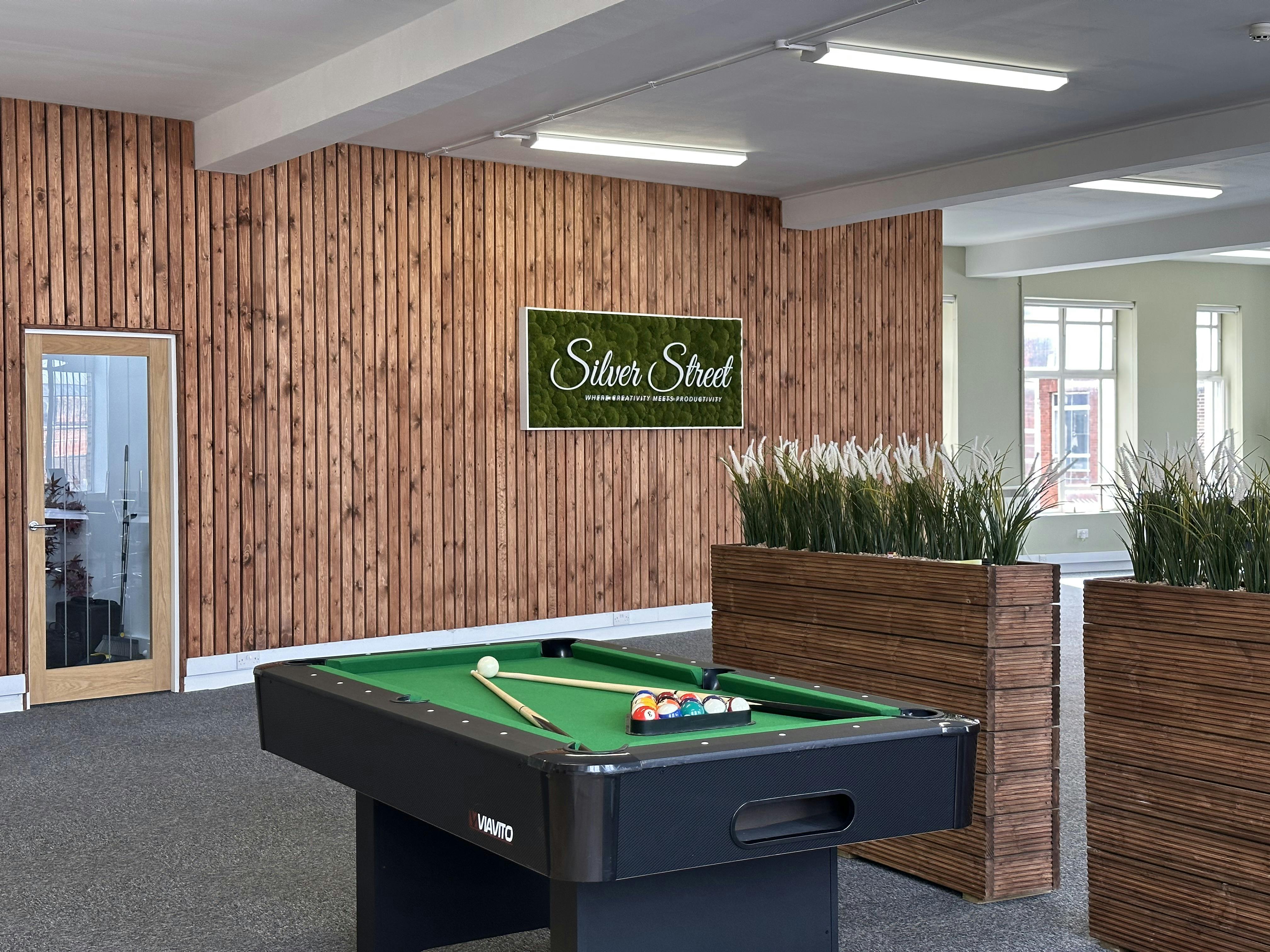 Modern office space with pool table, ideal for meetings and team bonding.