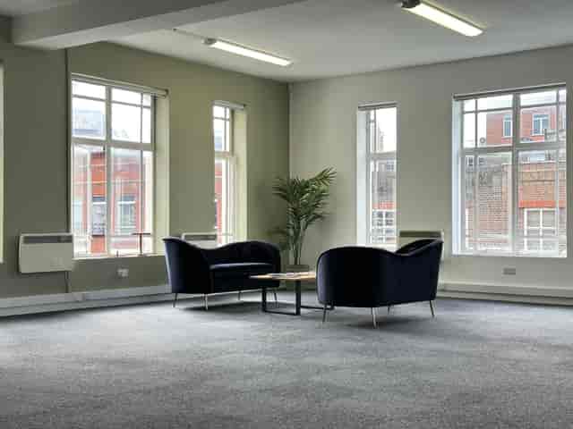 Modern minimalist meeting space with armchairs, ideal for brainstorming sessions.