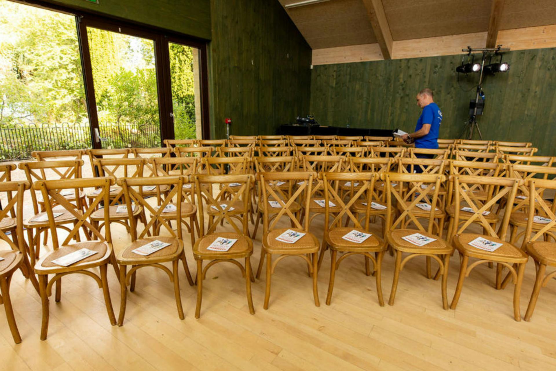 Main Hall event space with organized chairs and agendas, ready for meetings in Sands End.
