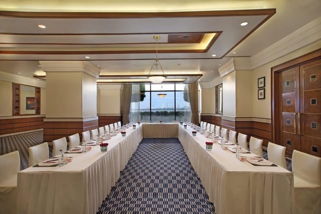 Corporate meeting room at Sunset Lounge, Mumbai with elegant decor and natural light.