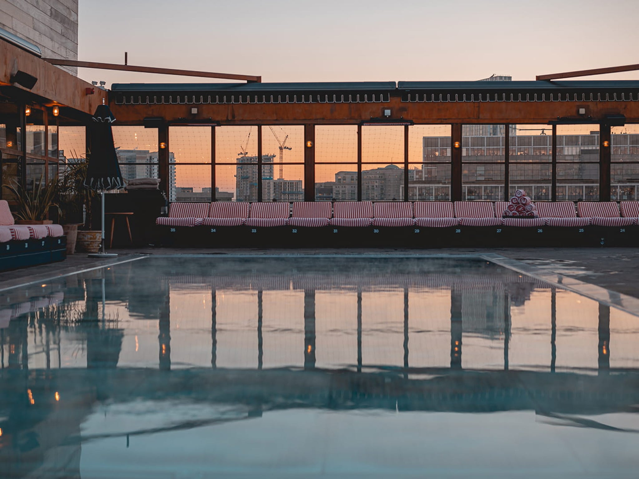 Stylish Shoreditch House rooftop venue with serene pool for upscale events. - Banner