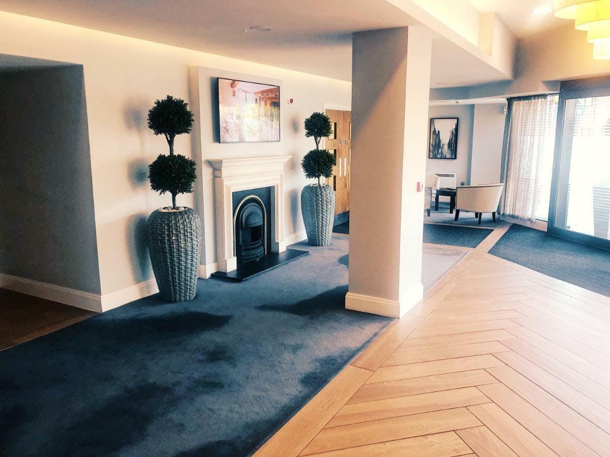 Wooden-floored lobby with elegant decor, ideal for networking events and gatherings.