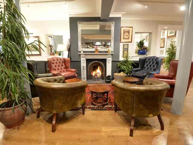 Cozy wooden lounge with armchairs, ideal for networking events and informal meetings.