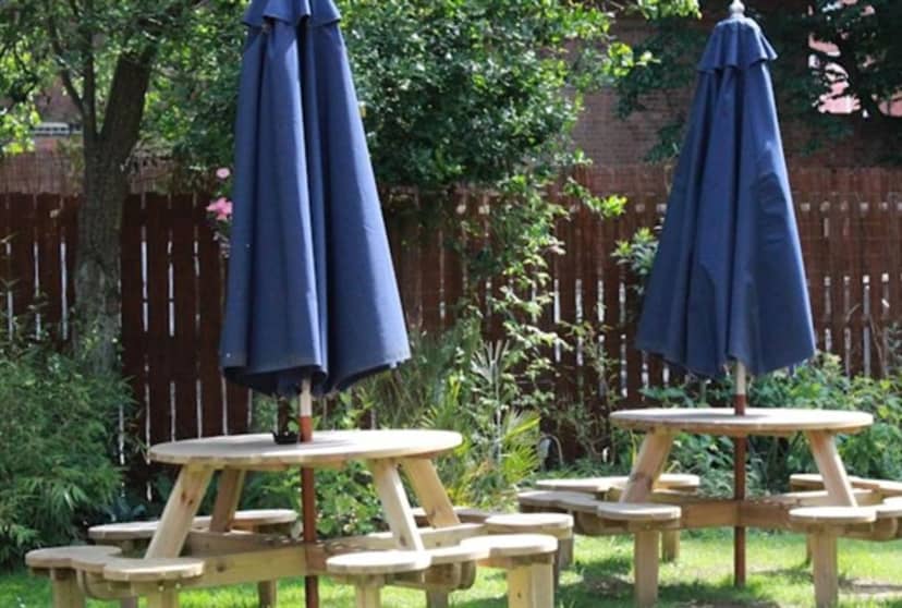 Outdoor garden seating at The Blue Piano for casual networking events.