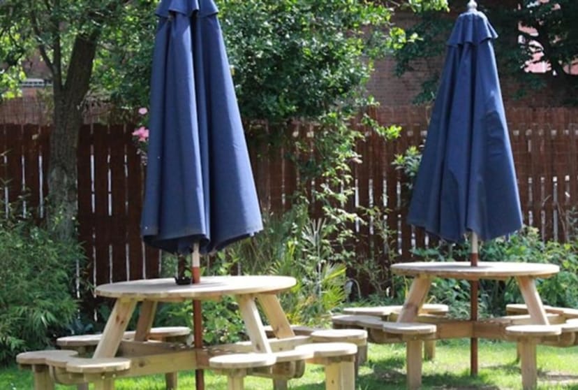 Outdoor garden seating at The Blue Piano for casual networking events.