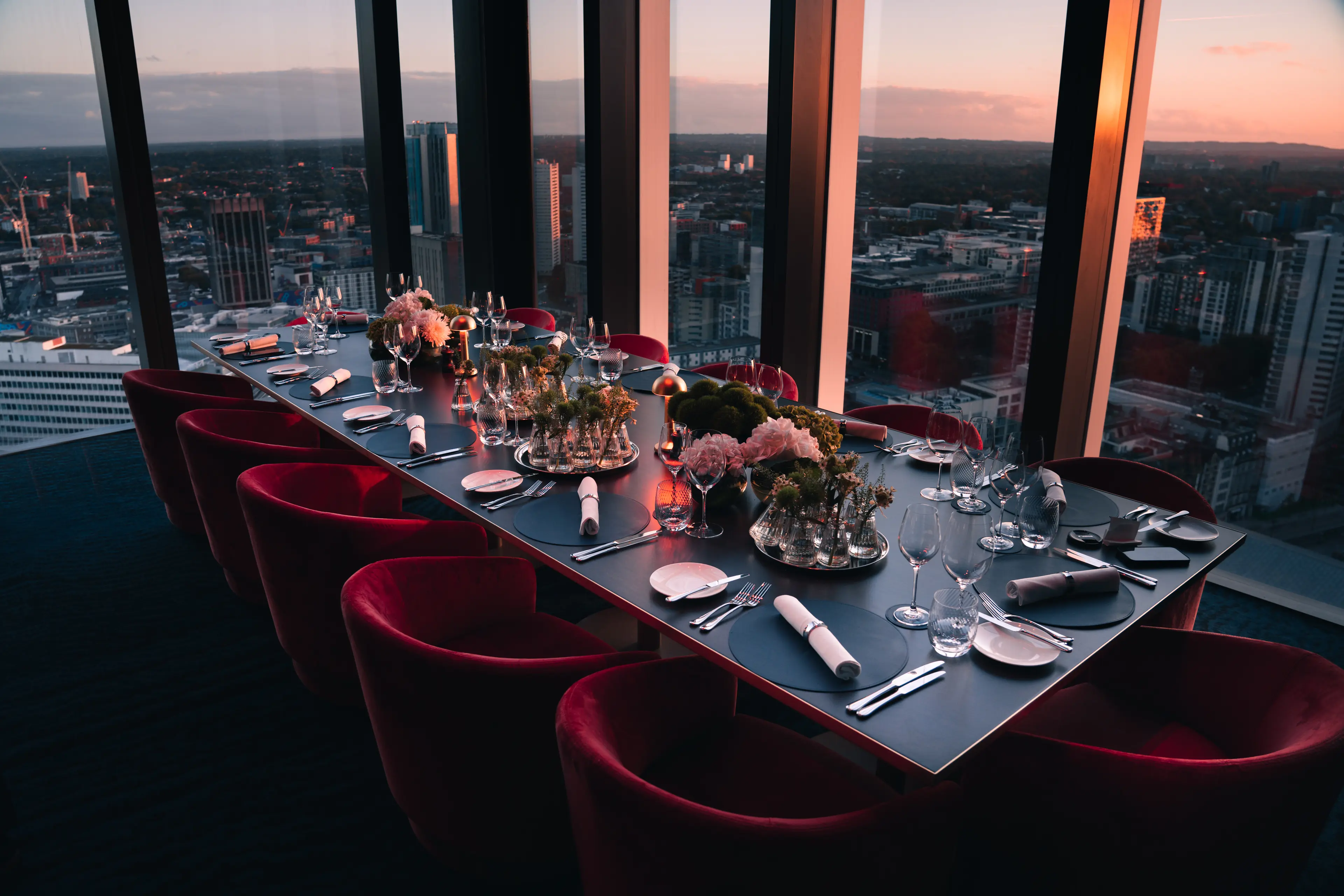 Private dining room in Orelle with elegant table setup and cityscape view for corporate events. - Banner