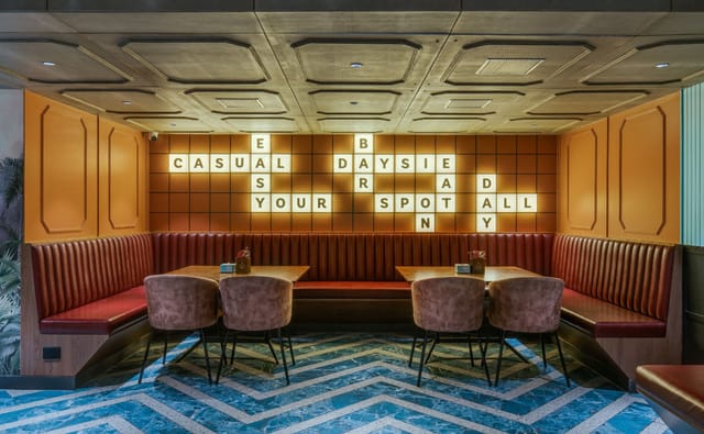 Stylish meeting space with cozy booths for casual gatherings and team-building events.