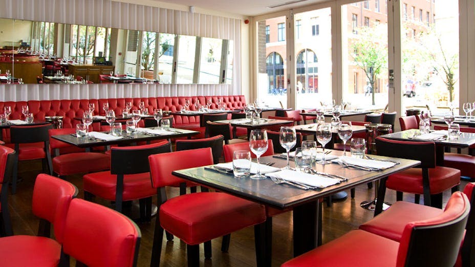 Modern restaurant in Piccolino Birmingham with red seating, ideal for events and gatherings.