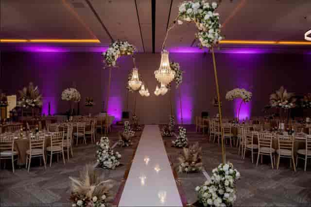 Elegant wedding venue at Old Farm Hotel with chandeliers and floral arrangements.