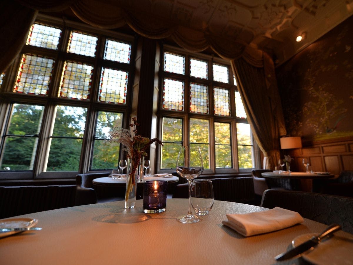 Elegant dining space with stained glass windows, perfect for upscale events in Hampton Manor.