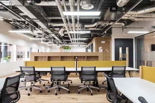 Modern open-concept office space with ergonomic seating for workshops and meetings.