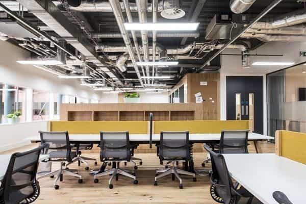 Modern open-concept office space with ergonomic seating for workshops and meetings.