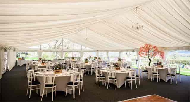 Luxury glazed garden marquee with elegant tables for weddings in Bordesley Park.
