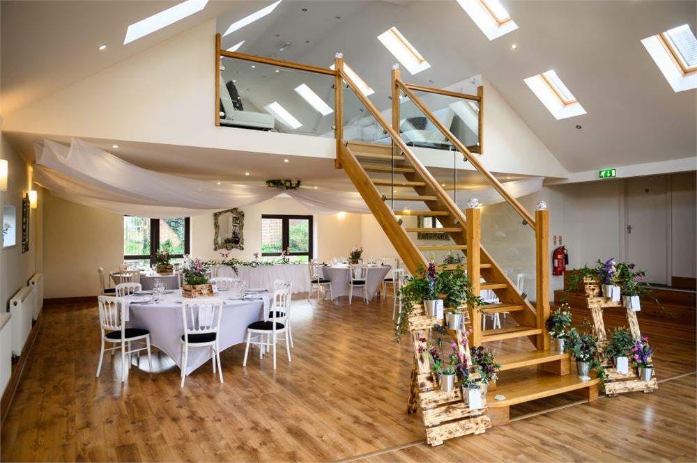 Bishops Barn wedding venue with elegant round tables and natural light for events.