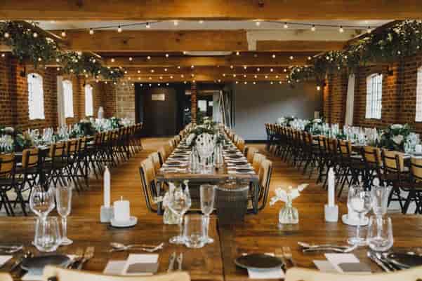 Elegant event space in Haarlem Mill with floral centerpieces, ideal for weddings and gatherings.