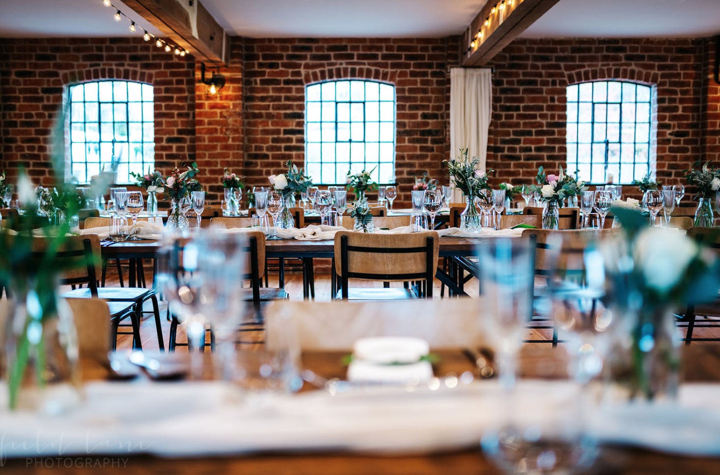 Elegant reception room in Haarlem Mill with floral centerpieces, perfect for weddings and events.