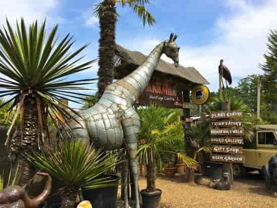 Tropical House at Akamba Venue with giraffe sculpture, perfect for unique outdoor events.