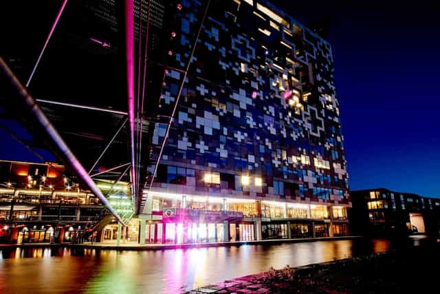 Modern Cube Hotel Birmingham at night, ideal for events and receptions by the waterfront.