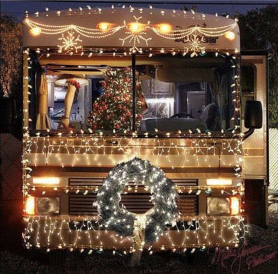 Festive RV with lights and wreath for holiday gatherings and outdoor events.