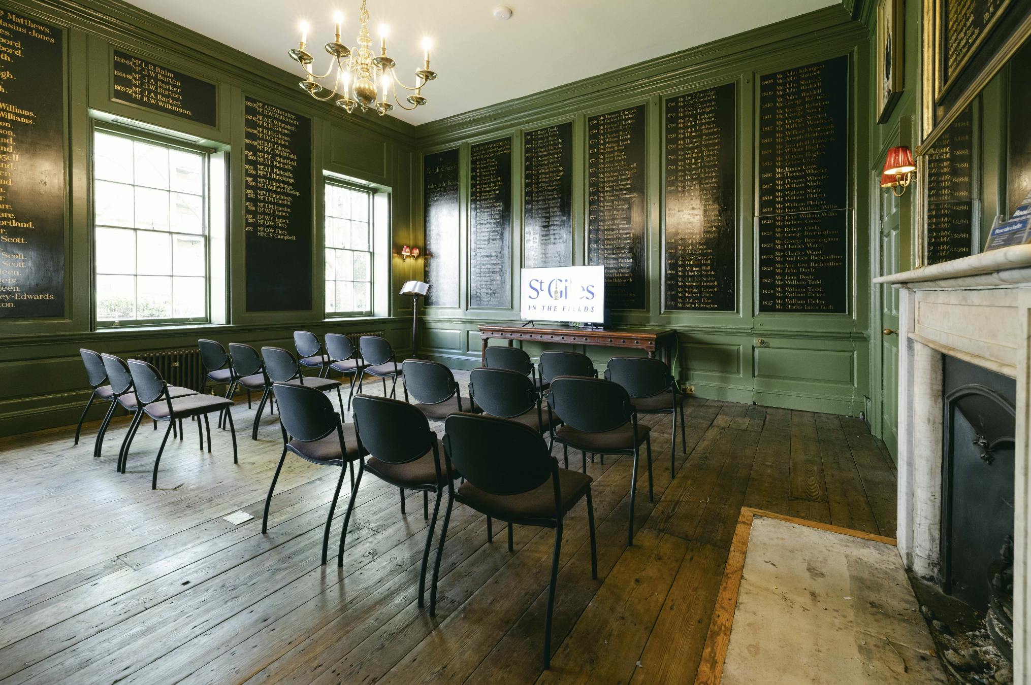 Vestry House meeting room with dark green walls, ideal for seminars and workshops.