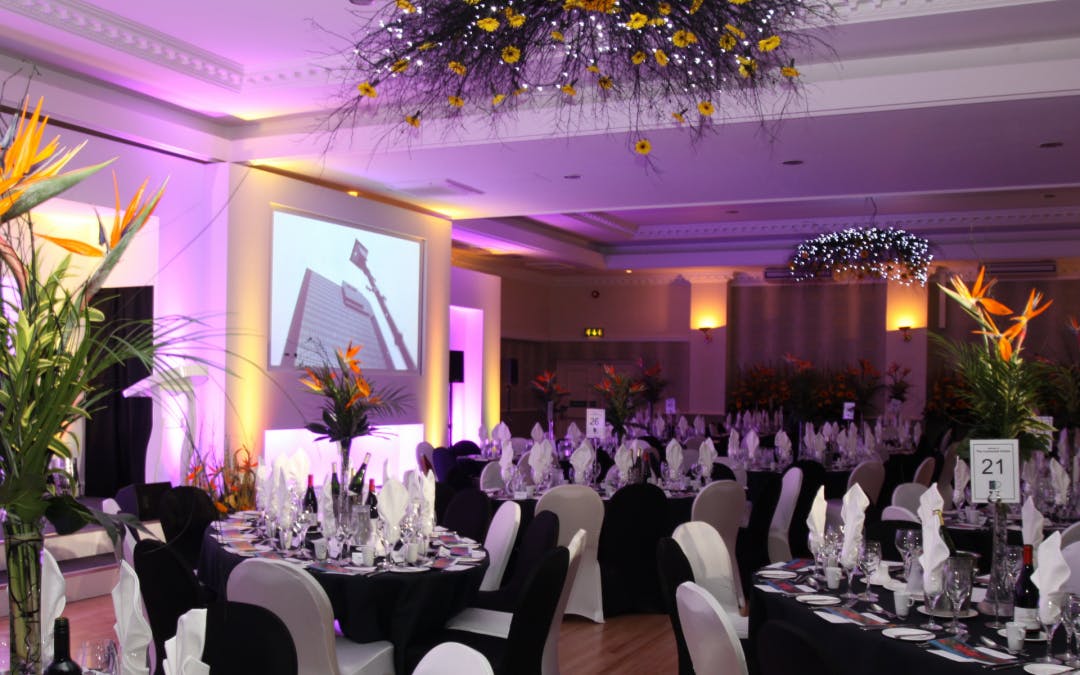 Elegant event space with floral centerpieces for corporate charity gala.