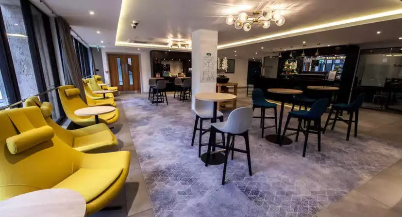Modern BCEC meeting room with vibrant yellow chairs for networking events.