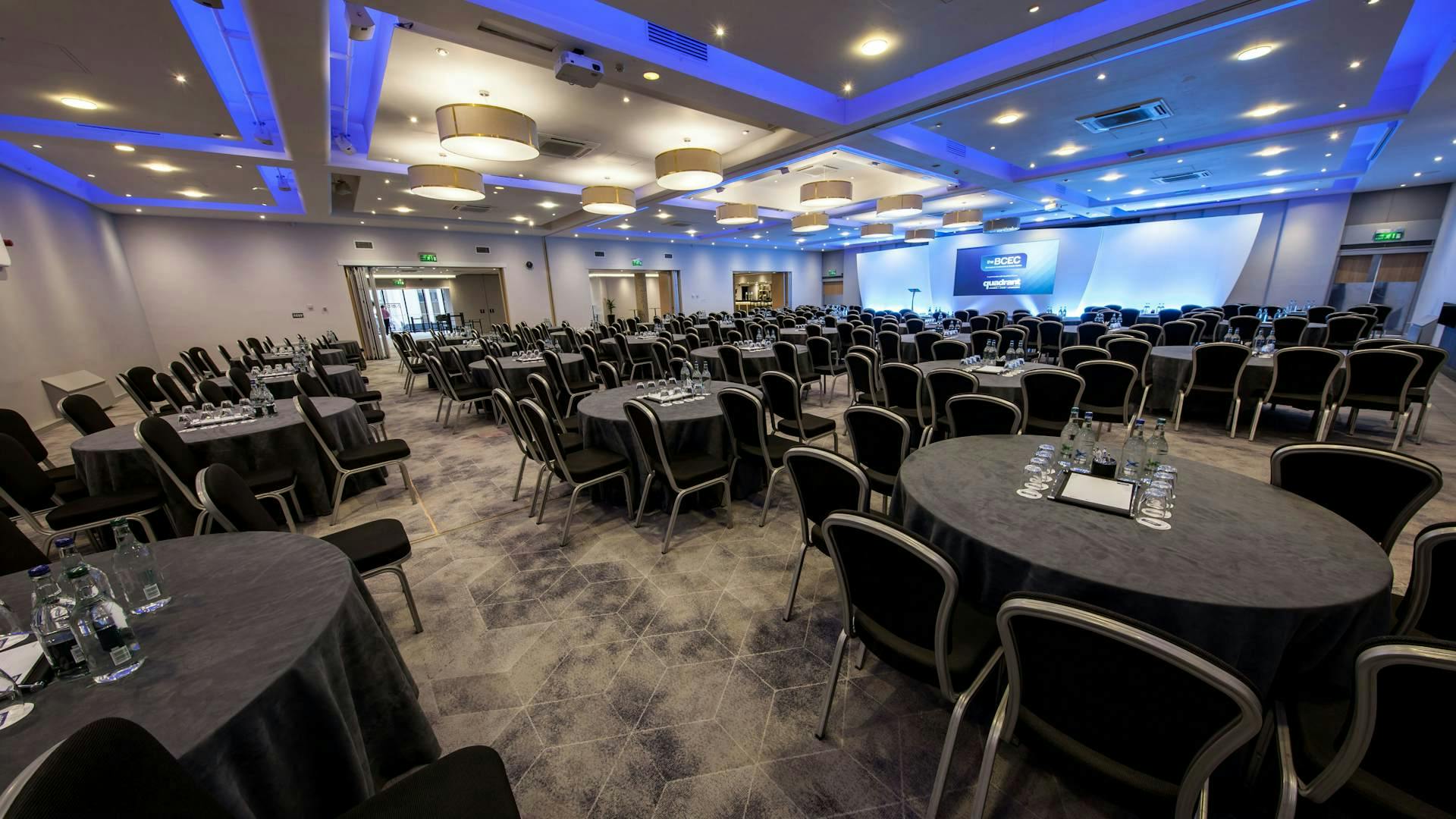 Mercian Suite at BCEC, spacious venue with round tables for corporate events.