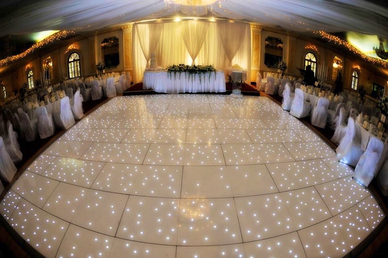 Elegant Regency Banqueting Suite with illuminated dance floor, ideal for weddings and events. - Banner