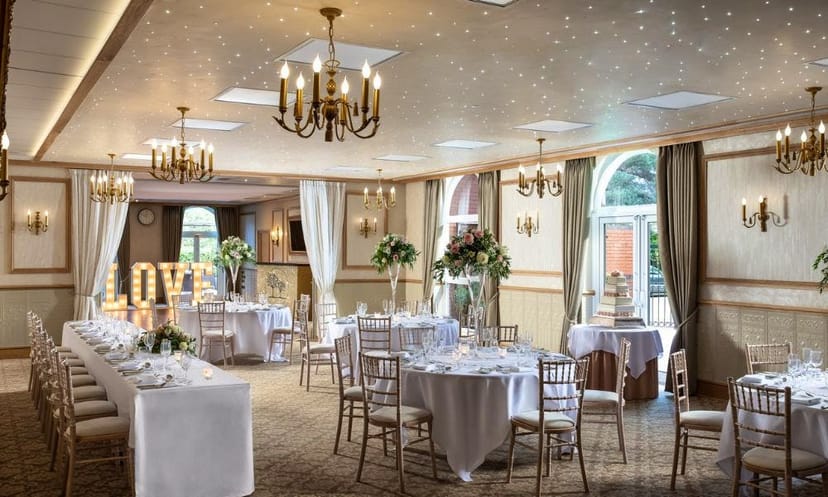 Elegant wedding venue with floral decor and romantic "LOVE" display at Shama's Banqueting.