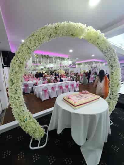 Shamas Hall wedding venue with floral arch and elegant cake, ideal for celebrations.