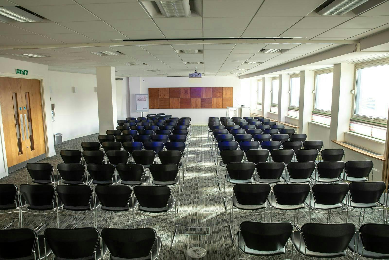 Well-organized meeting space with black chairs for corporate presentations and workshops.