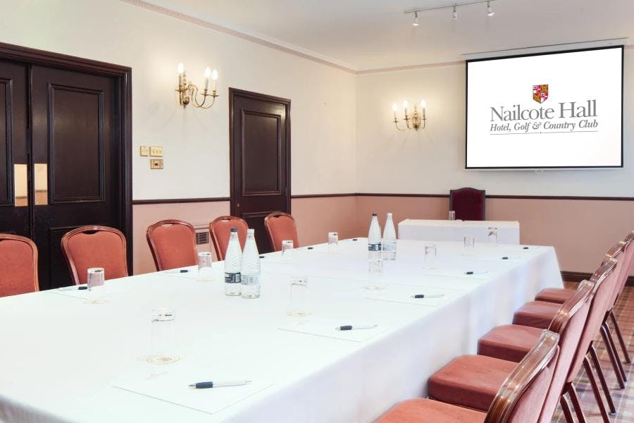 Wellingtonia Suite at Nailcote Hall: corporate meeting room with natural light and large screen.