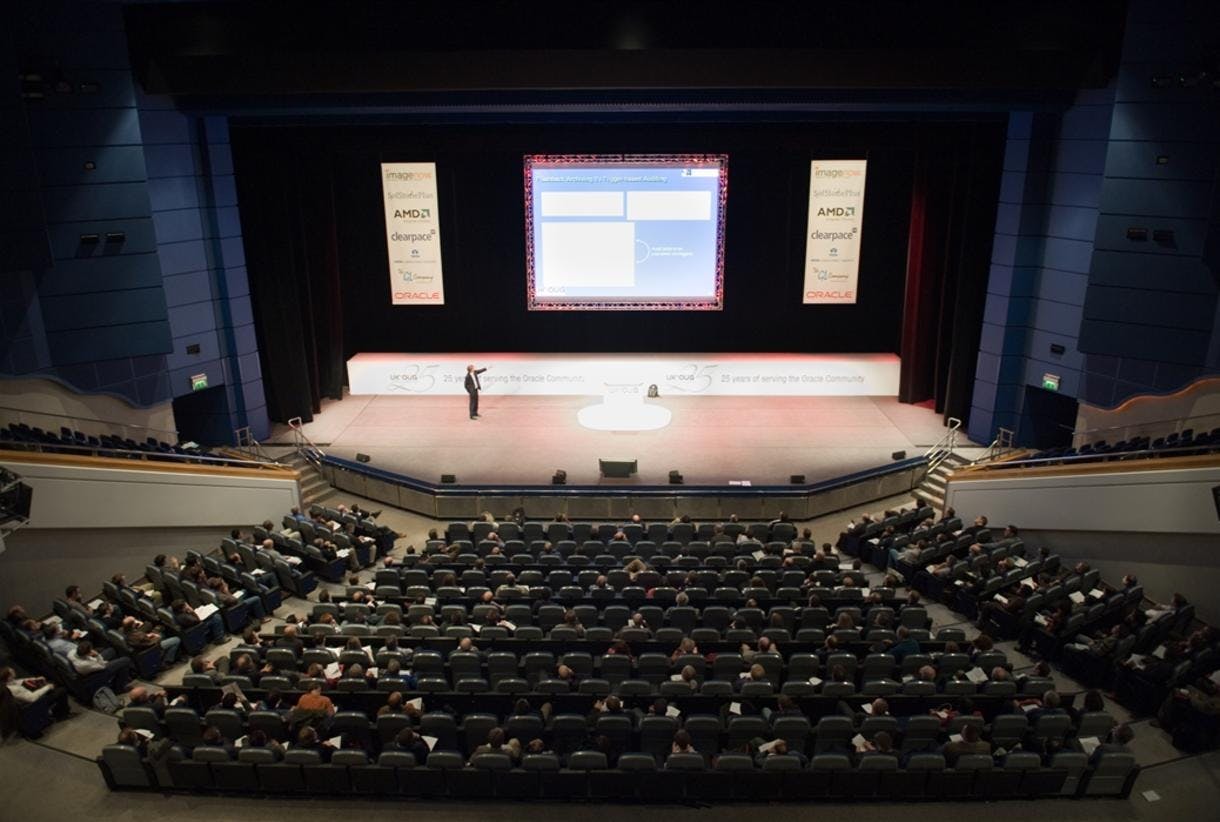 Spacious ICC Birmingham auditorium with attendees at a professional conference event.