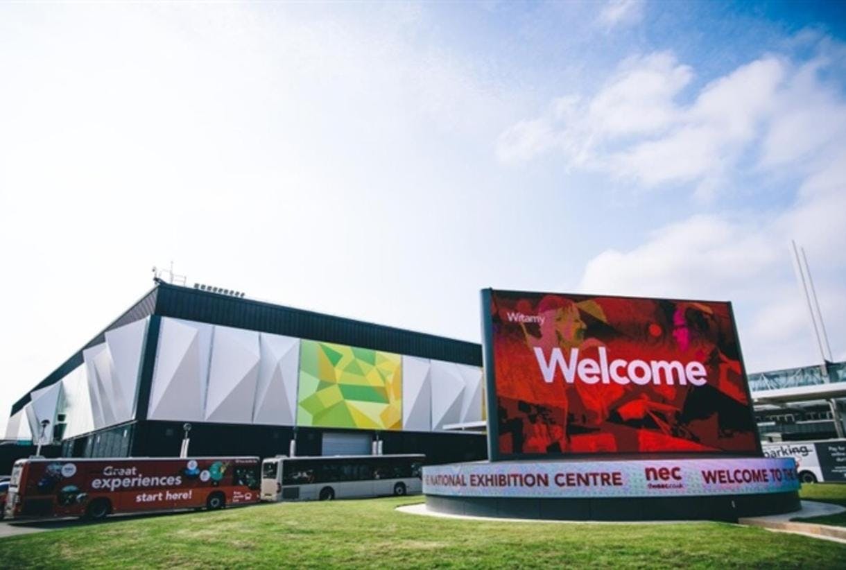 Vibrant entrance of NEC Birmingham with digital sign, ideal for events and exhibitions.