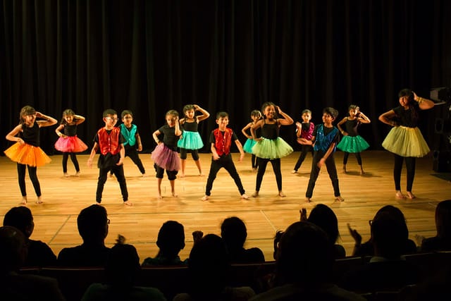 Children performing in colorful costumes at Aaja Nachle Let's Dance event.