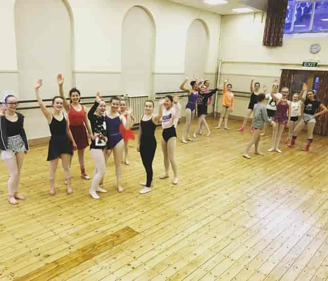 Vibrant dance rehearsal in spacious Rutleigh Norris School studio, ideal for workshops and performances.
