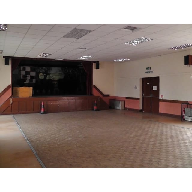 Spacious empty event venue with stage in St Chad's Erdington for meetings and performances.