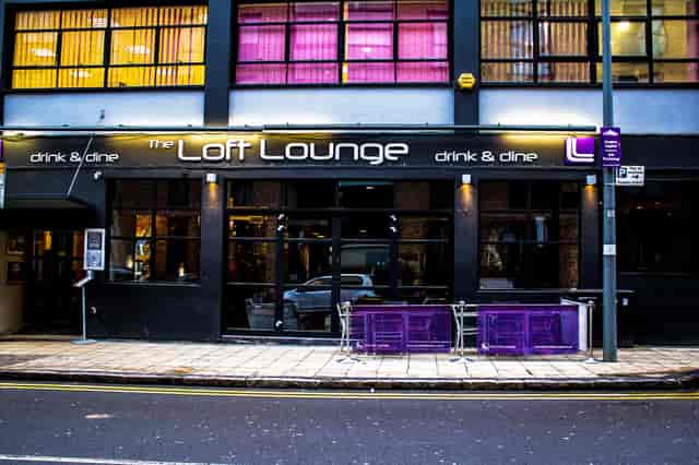 Modern event venue The Loft Brum with large windows and outdoor seating for gatherings.